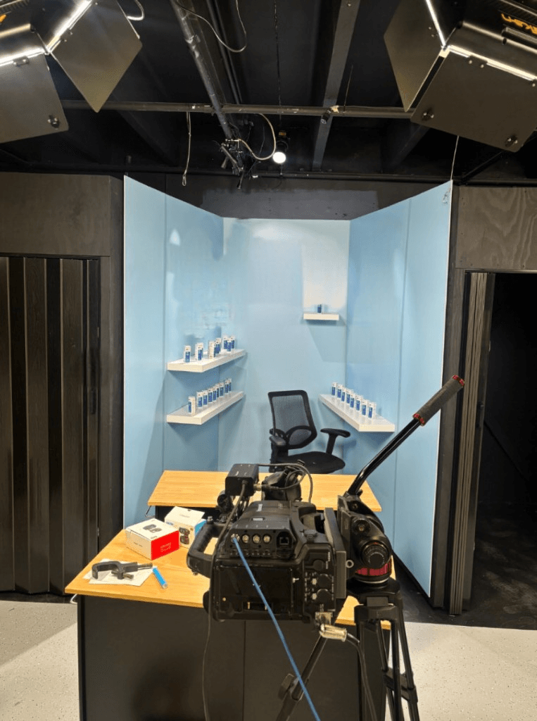 Camera, lighting, and product shelves in a dedicated live-selling booth